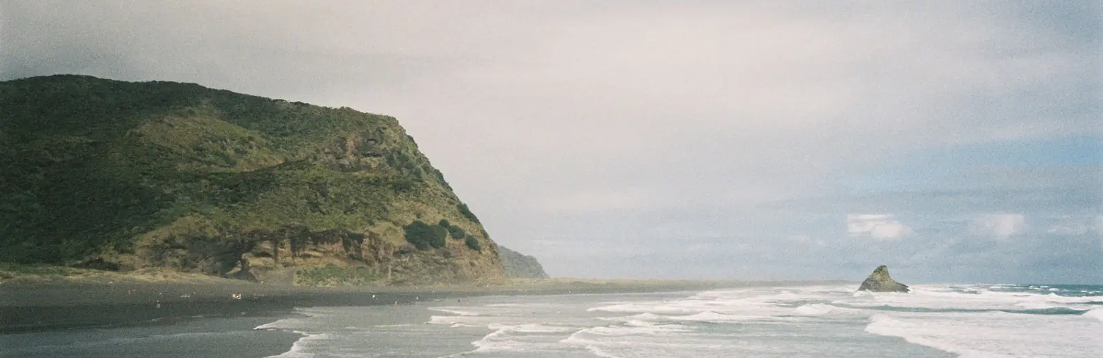 Cleaning services in Bethells Beach, West Auckland — Piha beach and cliffs on Auckland's west coast, home to the coastal homes and baches we clean