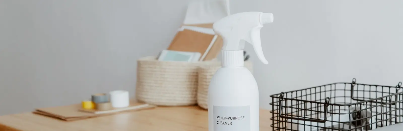 Eco-friendly cleaning spray and supplies on a desk ready for an Auckland office clean